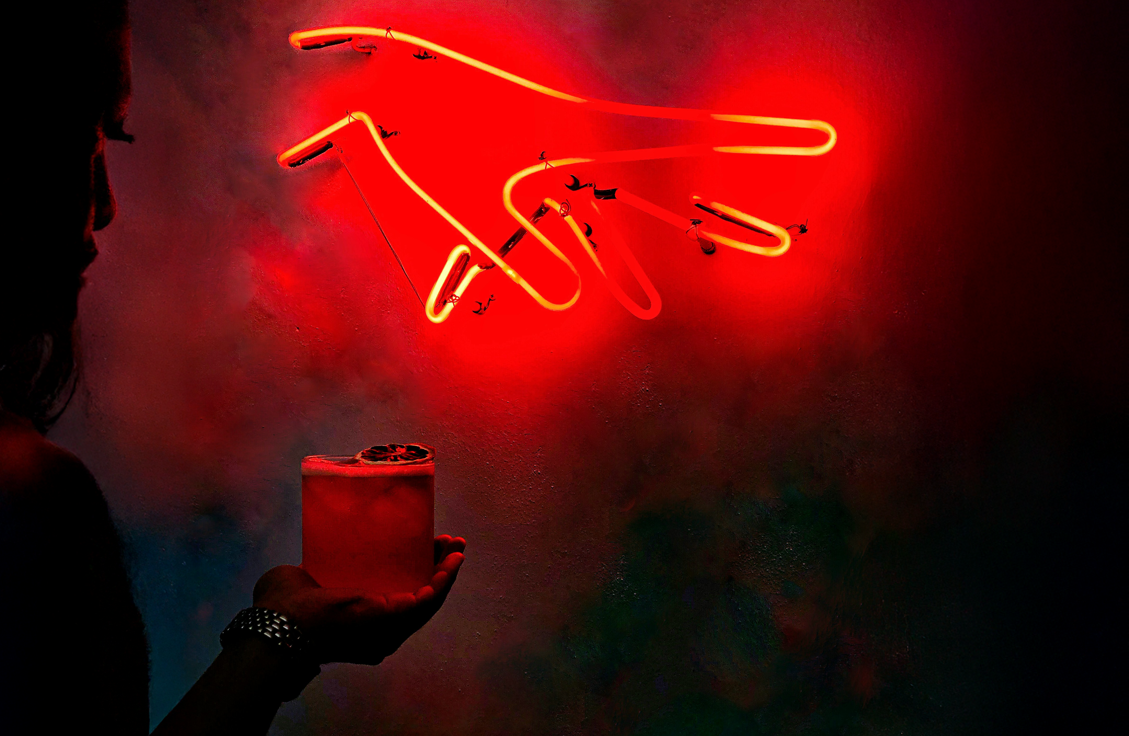 Neon hand sign with cocktail